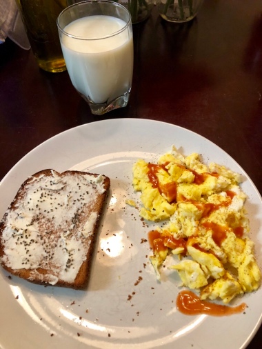 Scrambled eggs, toast with cream cheese and chia seeds